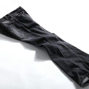High-quality photo of neatly folded dark denim pants on a white background, showcasing fashion details.